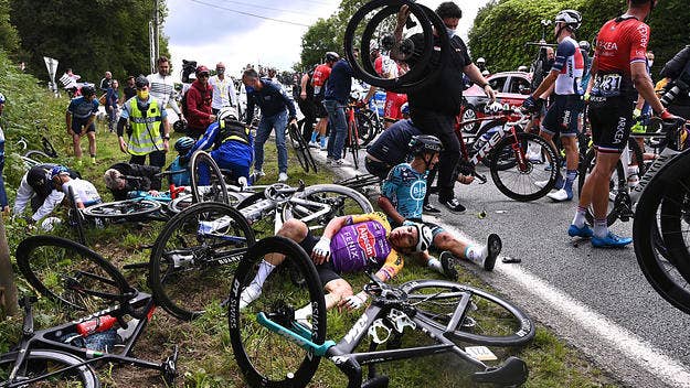 The spectator who caused a massive crash on Saturday during the Tour de France has allegedly fled the country as the competition's authorities look to sue her.