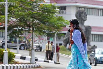 Indian businesswoman with a mobile phone at the center of technology in Kerala called technopark.