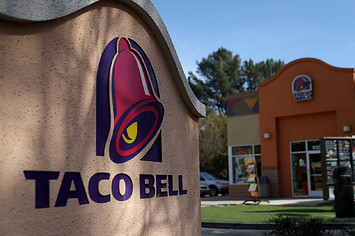 A sign is posted in front of a Taco Bell restaurant.