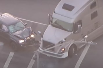 Screenshot of a car crashing into a big rig in California.