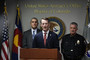 U.S. Attorney Jason R. Dunn, center, speaks during a press conference