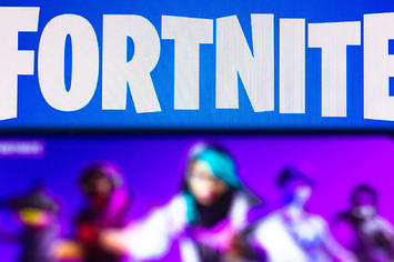 The Fortnite logo is seen on a smartphone and a PC screen.