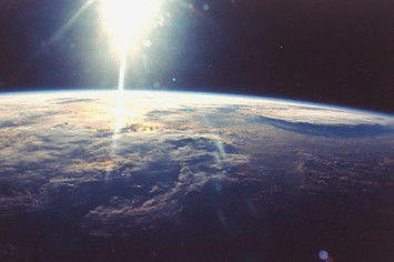 View of sunlight over Earth taken from space shuttle Discovery VIII mission.