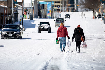 Texans walking through snow following winter storm