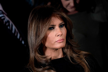Melania Trump listens to the US president deliver remarks.