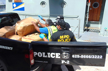 Police loading cocaine into truck