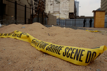 At the bombing site of the United States Embassy, crime scene tape lies on the ground.