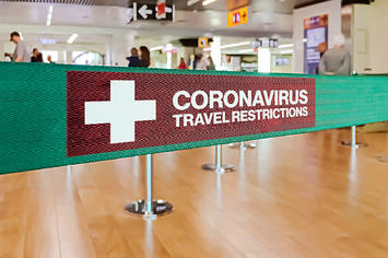 A sign advertising coronavirus travel restrictions.