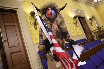 Protester screams "Freedom" inside the Senate chamber after the U.S. Capitol was breached.