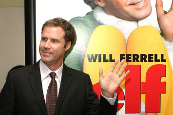 Will Ferrell poses alongside the poster for 'Elf'.