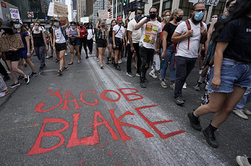 Demonstrators march during a protest in New York against the shooting of Jacob Blake.