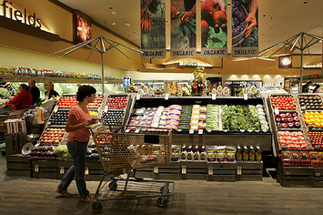A Safeway customer browses in the fruit and vegetable section at Safeway.