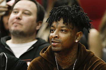 21 Savage watches from court side as the Denver Nuggets played the Houston Rockets