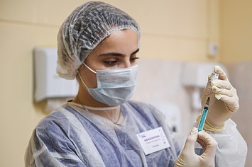 Russian woman administering Sputnik V vaccine