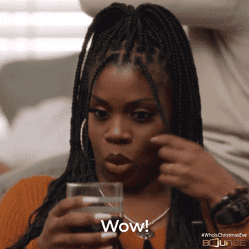 woman with a drink in her hand saying &quot;wow!&quot;
