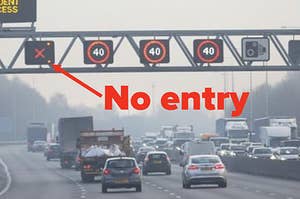 Cars driving along the motorway, with a red arrow pointing to a red X signal saying "No entry"