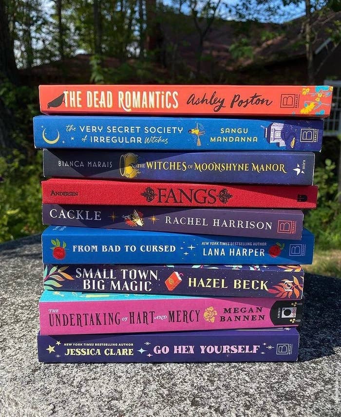stack of books including titles like from bad to cursed and the very secret society of irregular witches