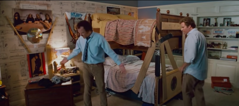 Two grown men get very excited about bunk beds