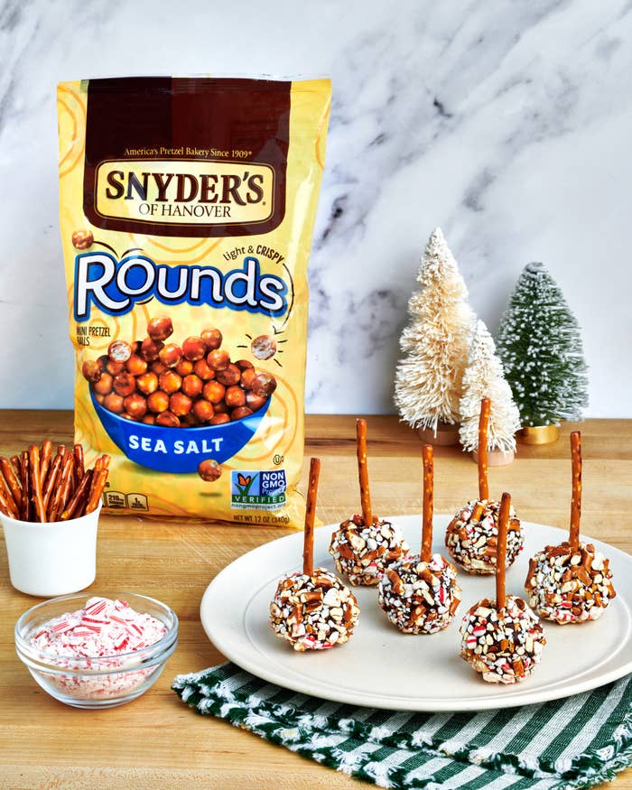 Truffle pops are plated in front of bag of pretzel rounds