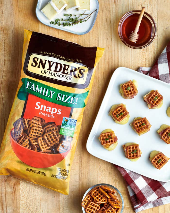 Pretzel bites sit on appetizer tray beside bag of pretzel snaps