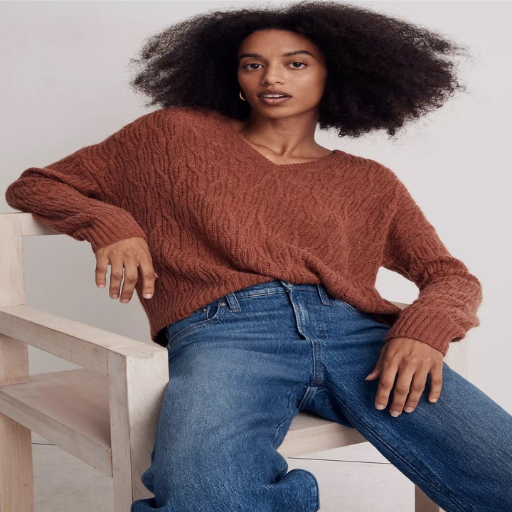 model in muted rust red v-neck sweater