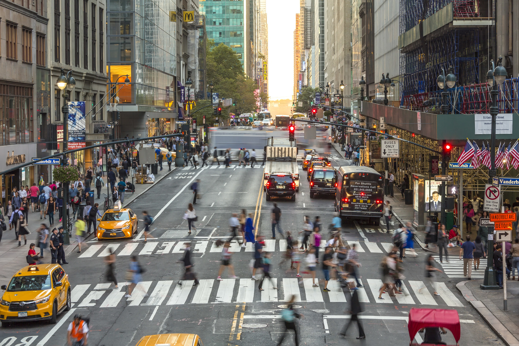 People walking a busy crosswalk in NYC.