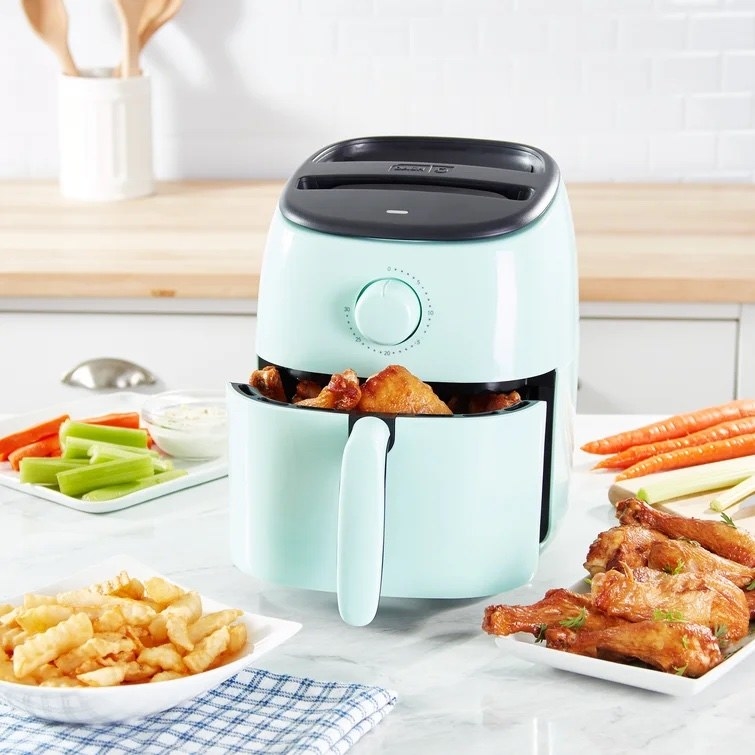 the mint colored air fryer on a countertop
