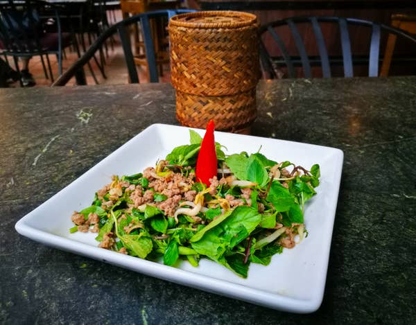 plate of larb salad on table in Laos