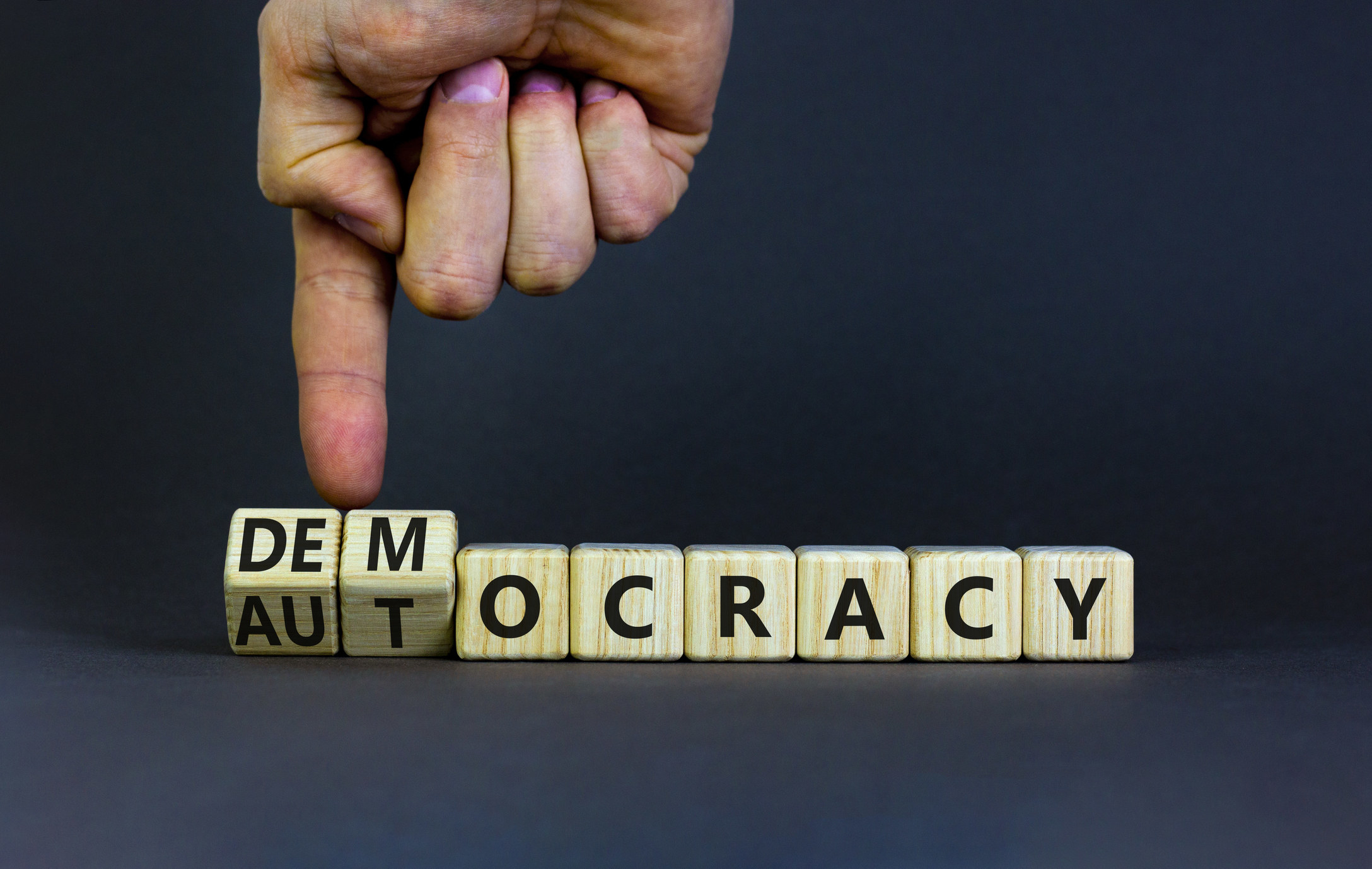 letter tiles changing from democracy to autocracy
