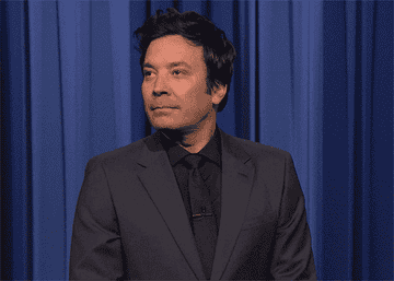 Fallon looking down, shaking his head, and raising his eyebrows, making an &quot;oof&quot; face