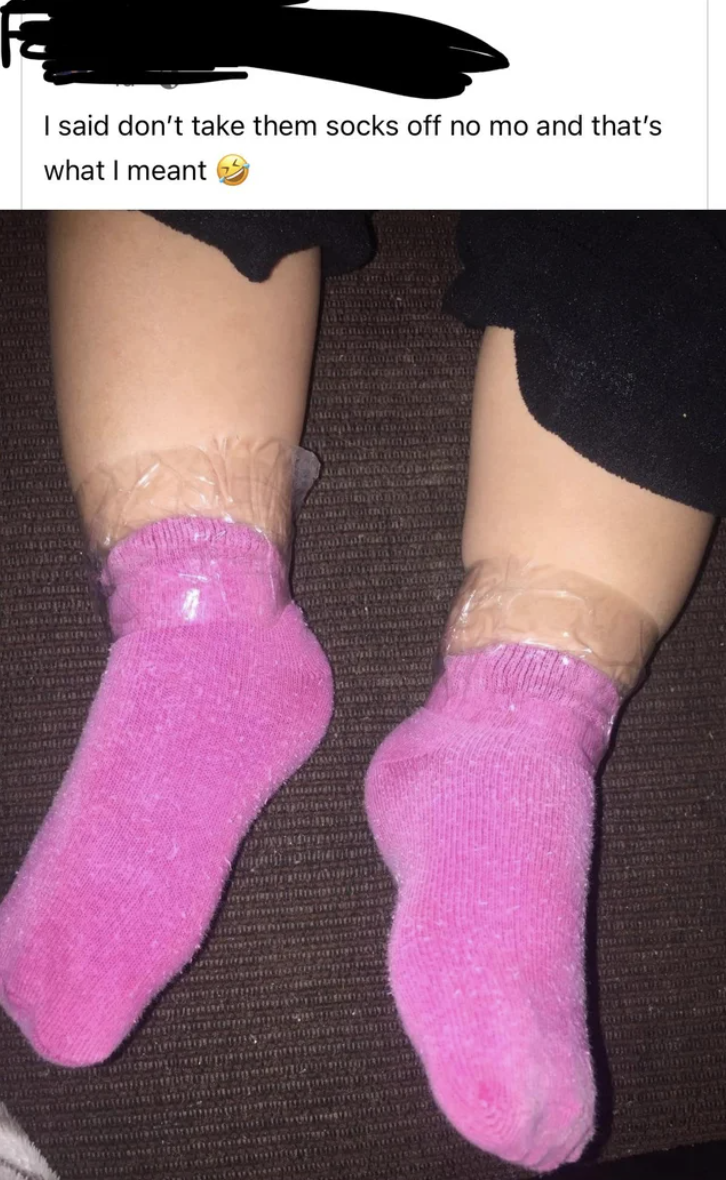 baby with socks taped onto their feet