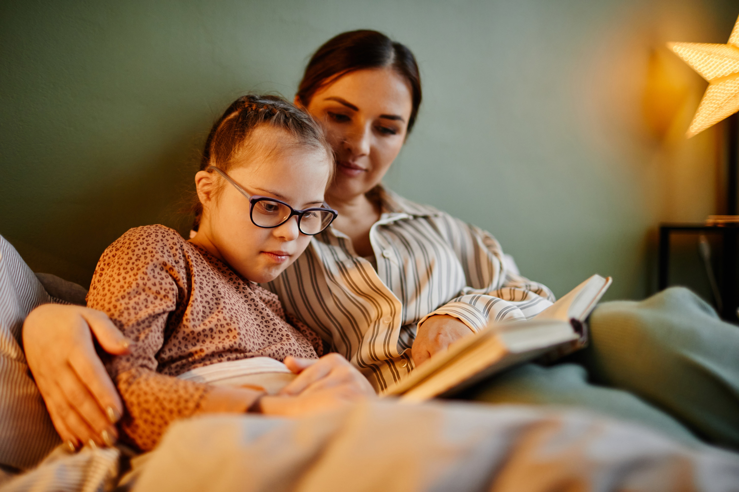 young mom reading with her daughter