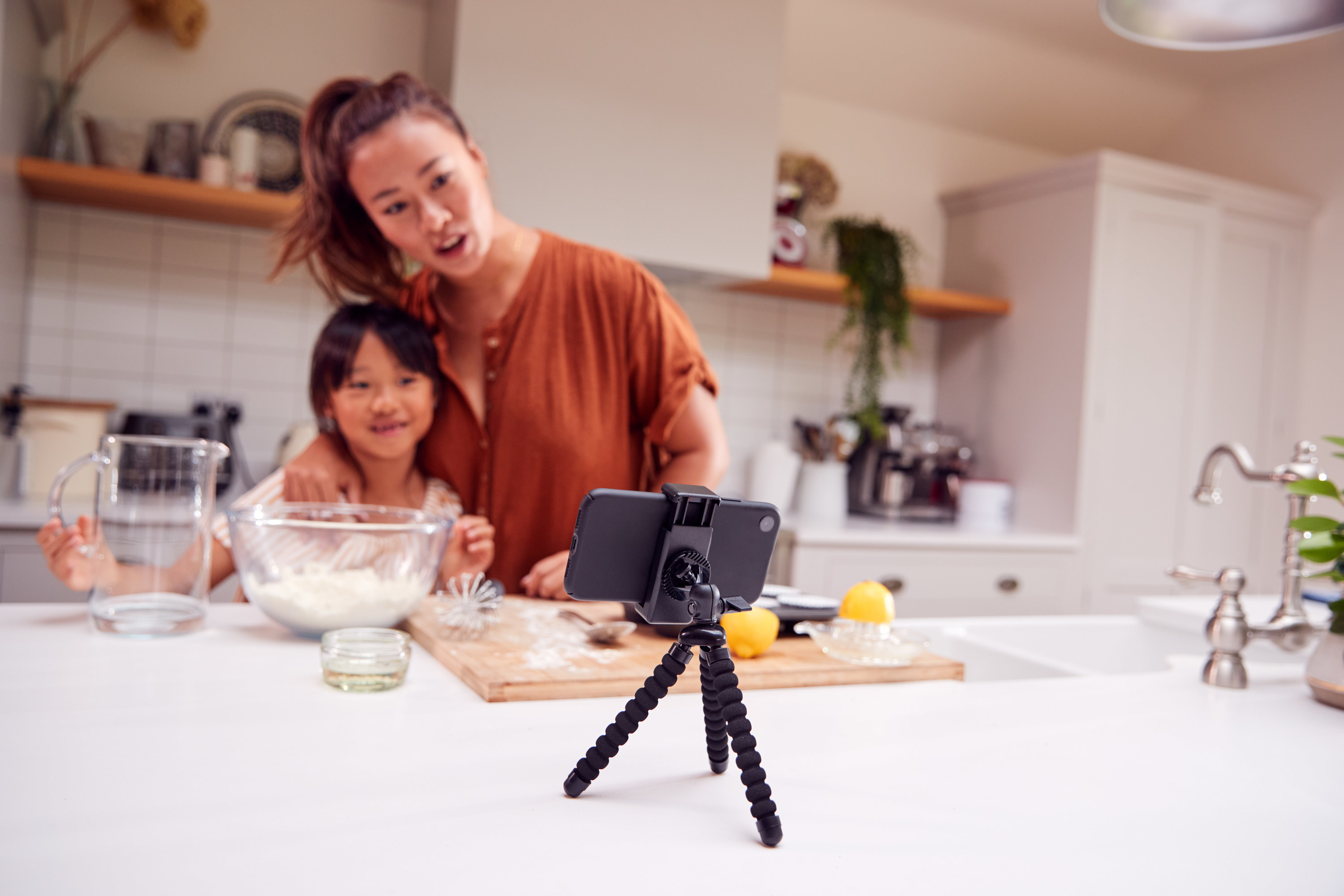 mom and daughter vlogging in their kitchen at home