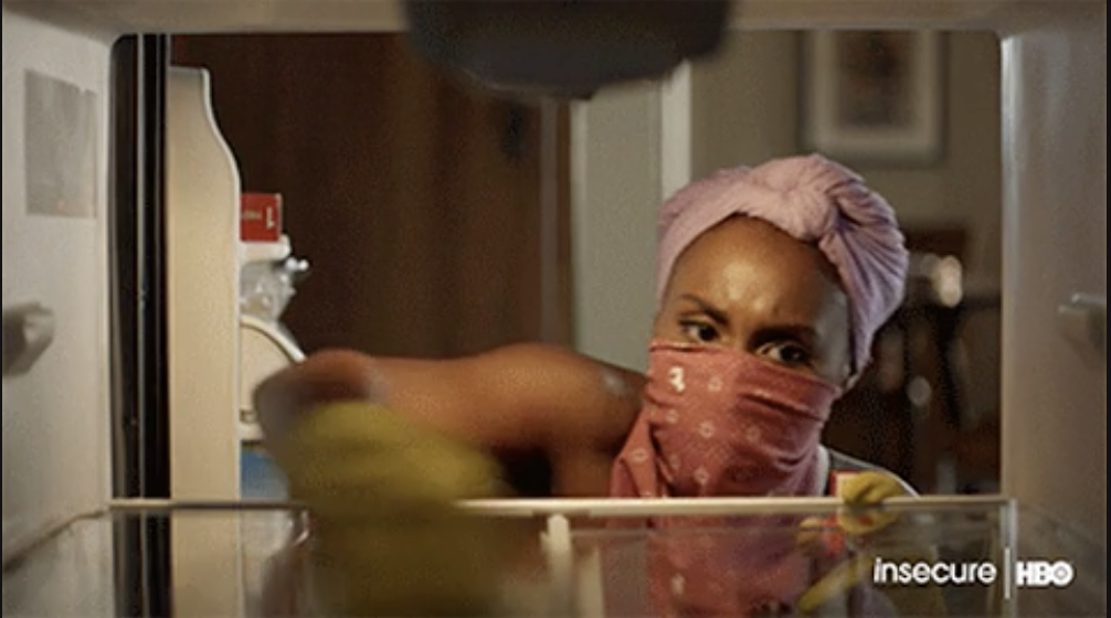 a woman cleaning the inside of a fridge