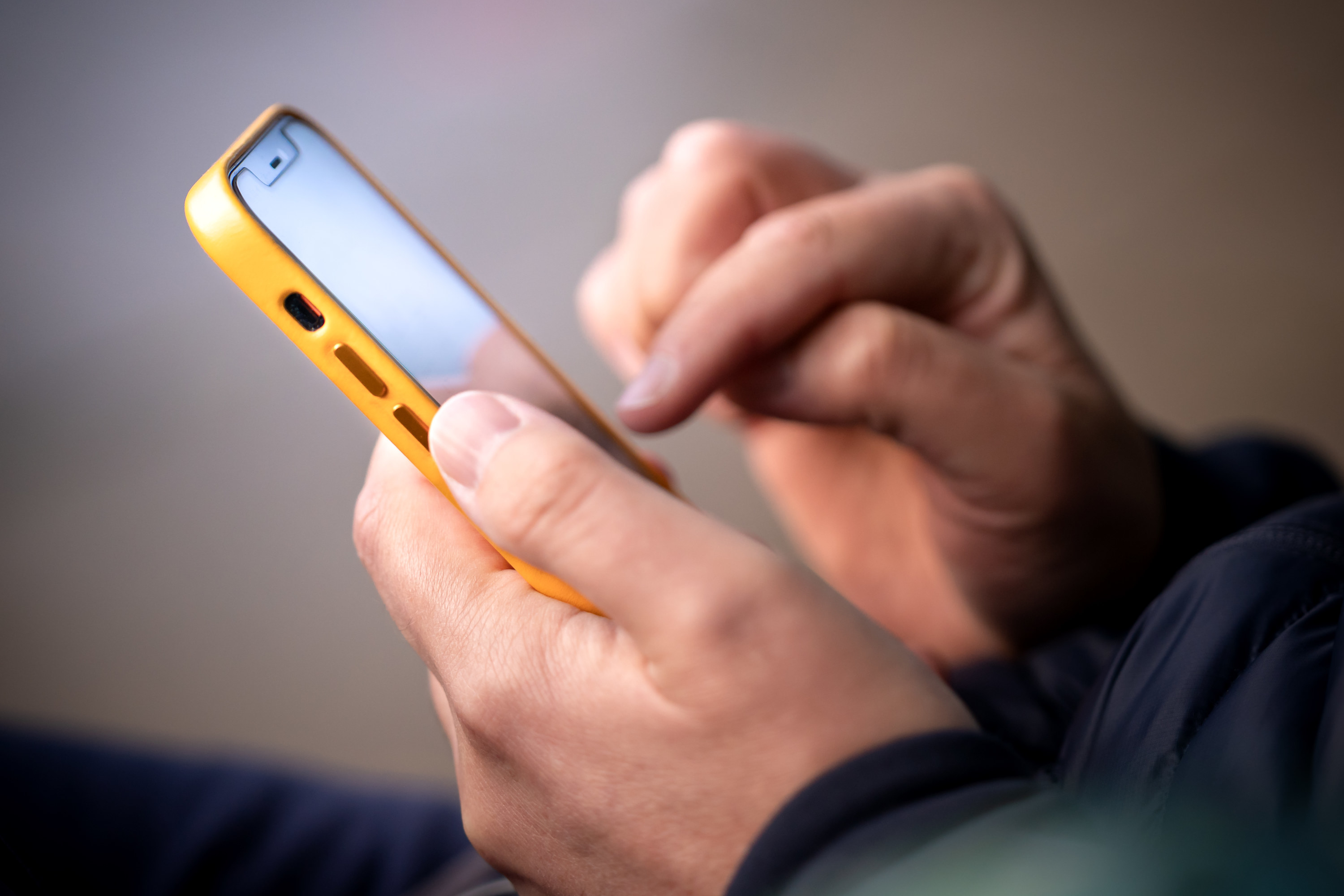 a hand touching a smartphone