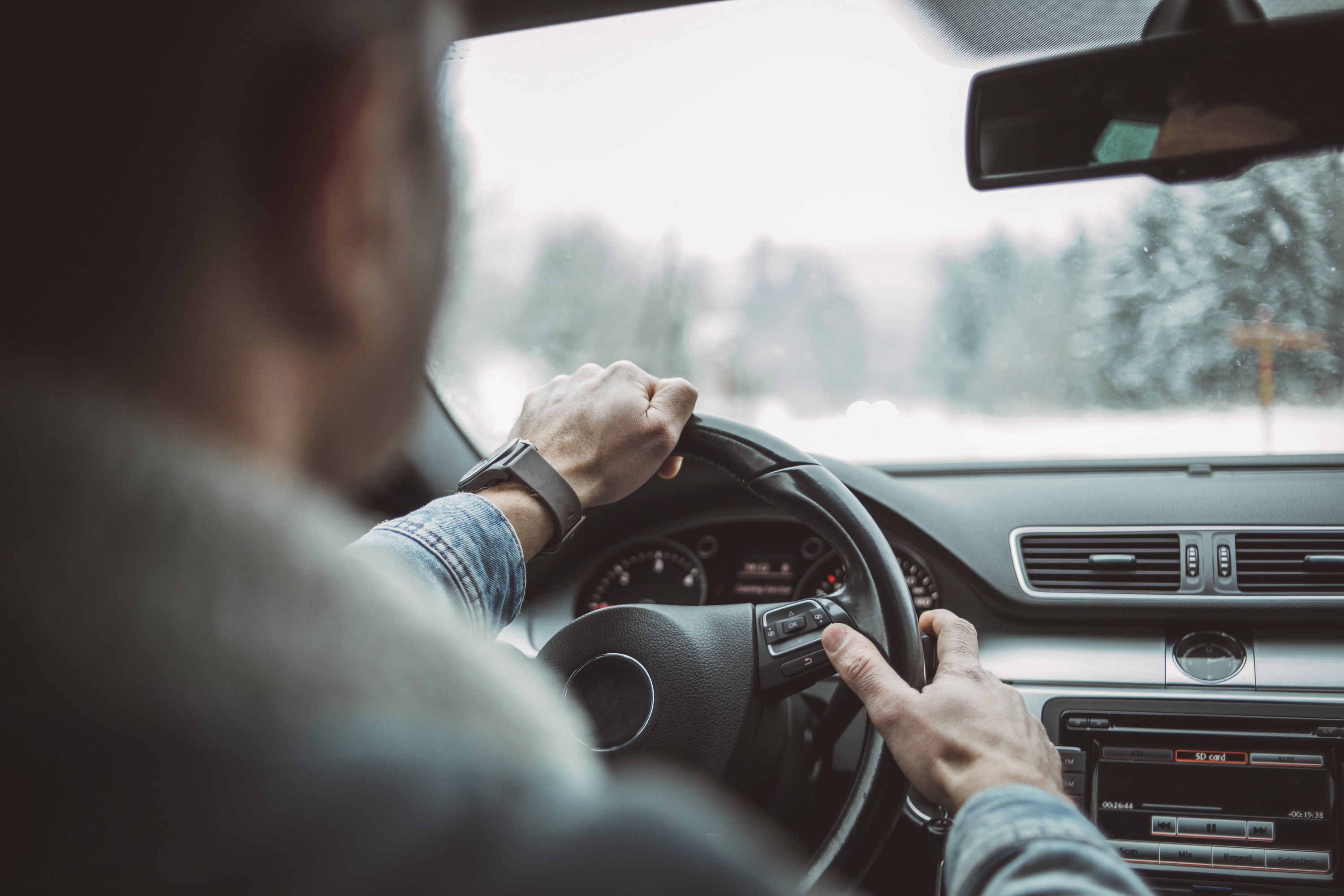 hands holding a steering wheel in a car