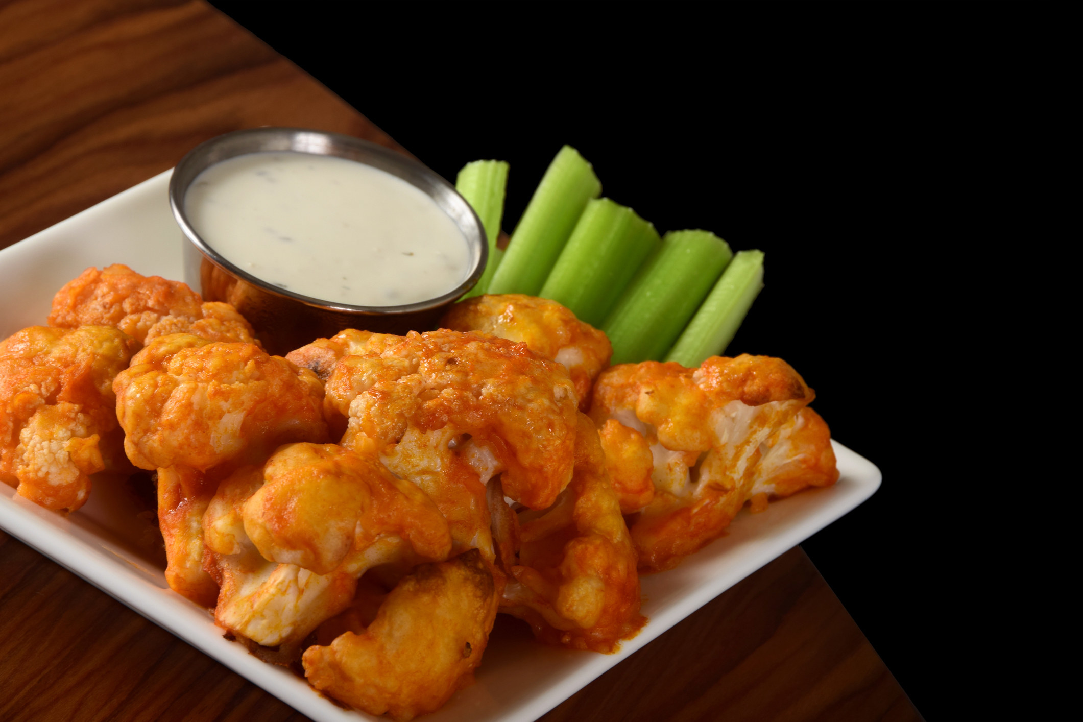 Buffalo cauliflower bites with blue cheese dressing and celery