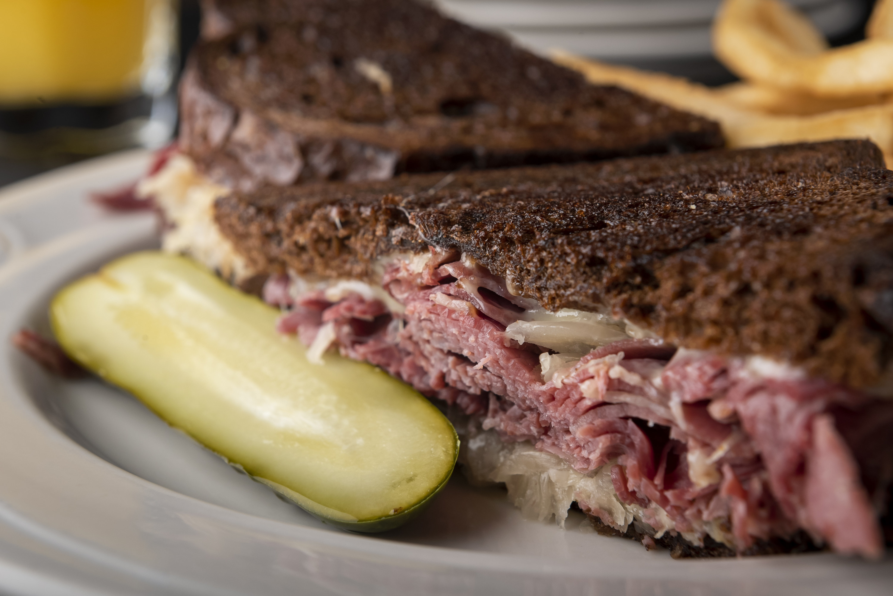 A Reuben sandwich with a pickle