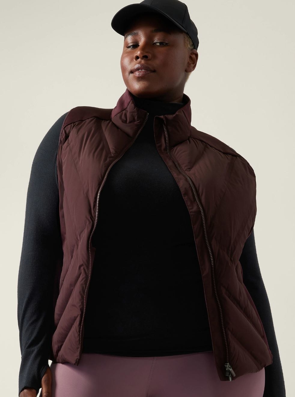 model wearing burgundy puffer vest