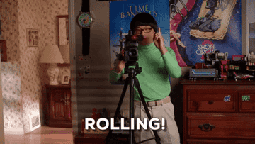 A person says &quot;rolling!&quot; while filming with a camera