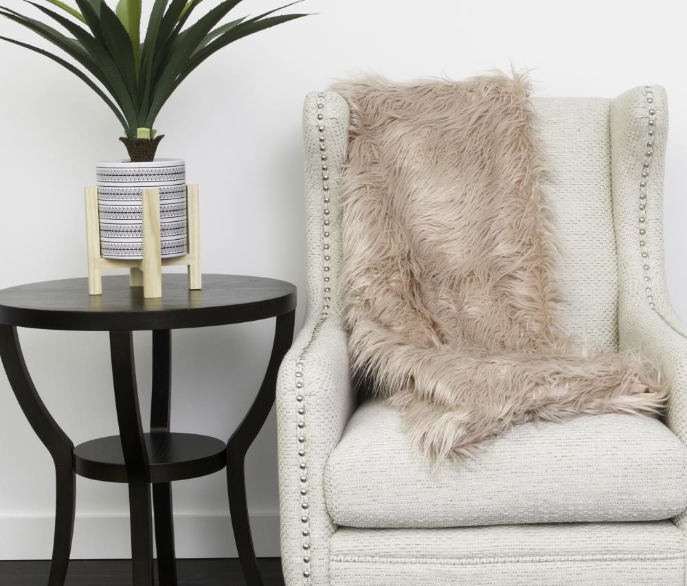 the throw blanket on an accent chair