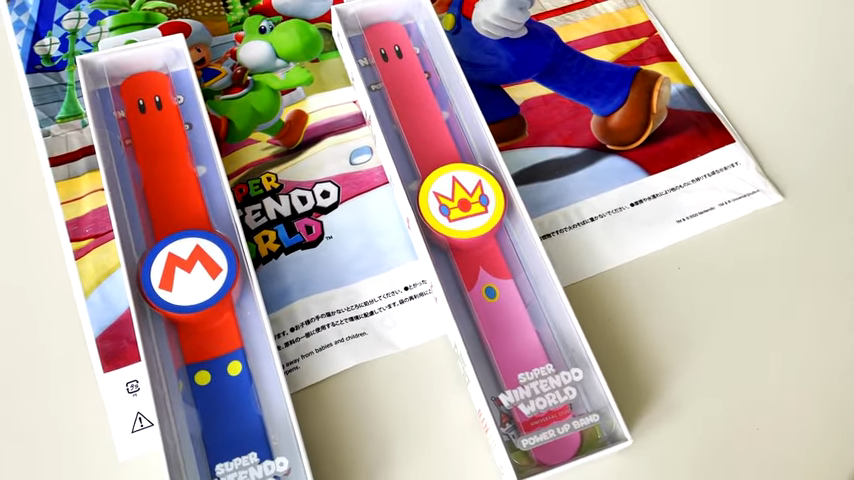 power up bands inside their cases with a mario and peach logo respectively