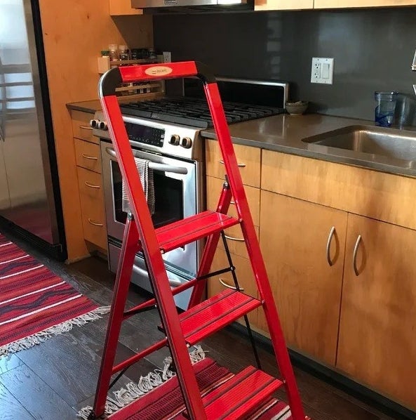 a reviewer photo of the red step stool in a kitchen