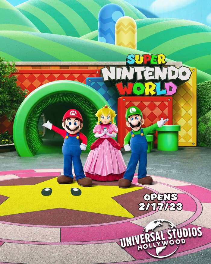 Mario, Peach, and Luigi standing inside Super Nintendo World