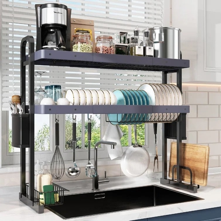 Black over the sink storage rack with utensils, plates, silverware, appliances, and canisters on it