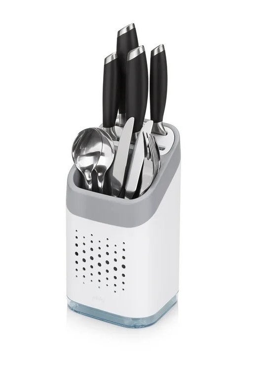 White flatware caddy with spoons, forks, and knives inside