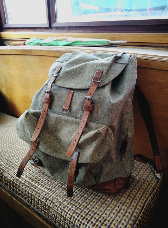A backpack with straps on a couch