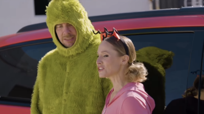 Dax wearing a Grinch costume in a commercial