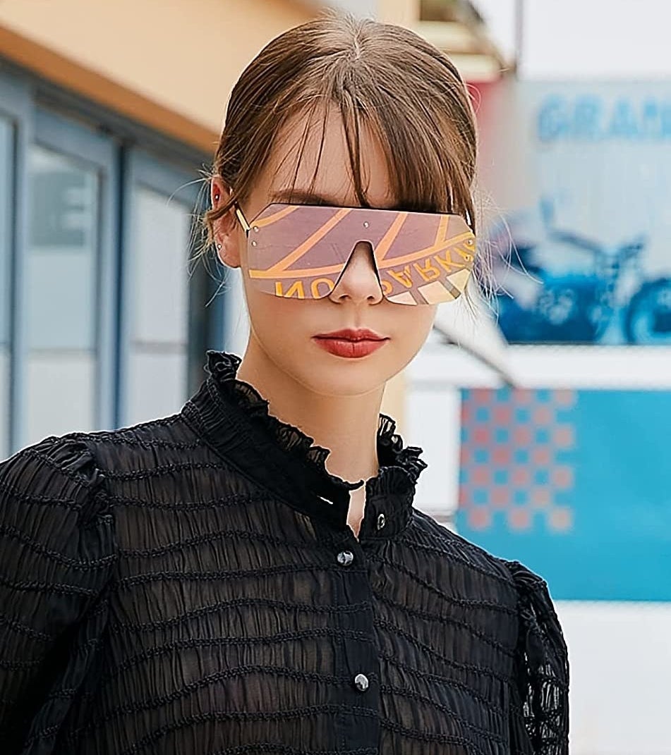 a person wearing the reflective sunglasses with a blouse