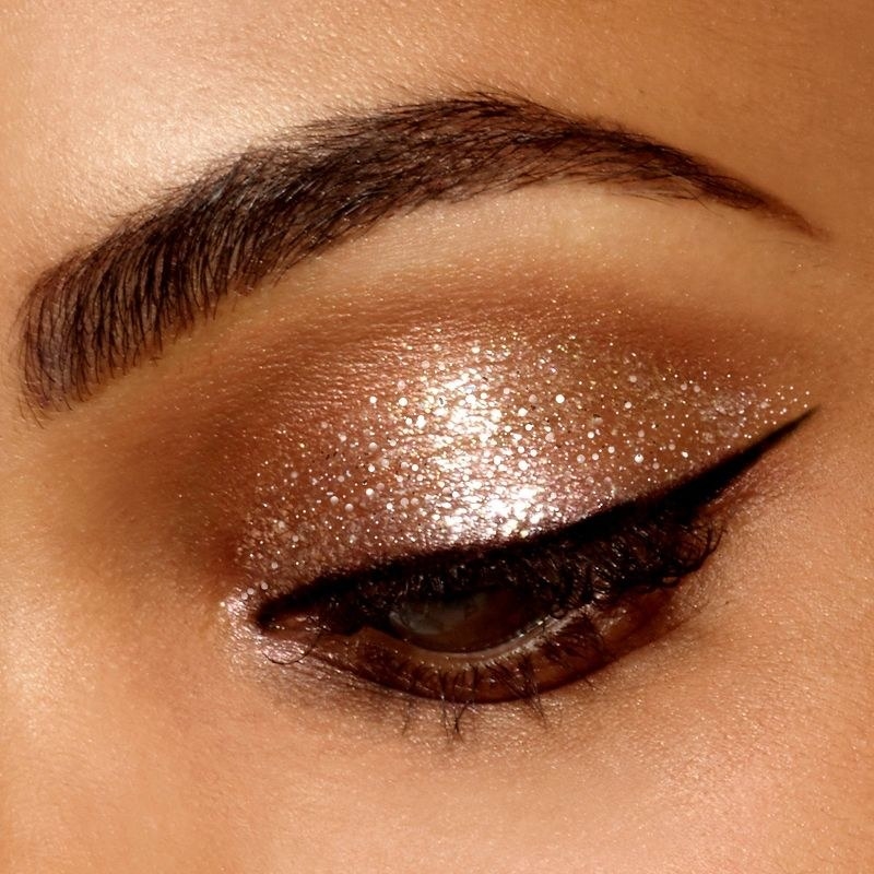 A person wearing liquid eyeshadow and a winged eyeliner
